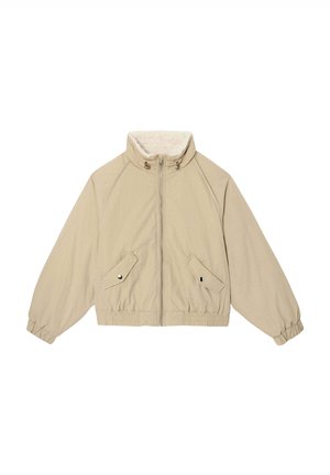 Veste beige courte avec un col haut, fermeture éclair, et manches raglan. Comprend deux poches latérales ainsi que des poignets et un ourlet élastiqués.