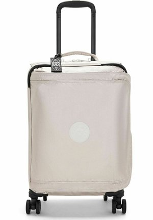 Cabin-sized suitcase in light beige fabric with black wheels and retractable handle; features a round white logo on the front.