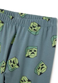 Katoenen pyjamabroek met een elastische tailleband, in een blauw-grijze kleur en met herhaalde groene gepixelde monstergezichten.