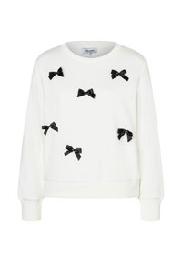 White sweatshirt featuring black ribbon bow embellishments and a round neckline. Designed with long sleeves and ribbed cuffs and hem.