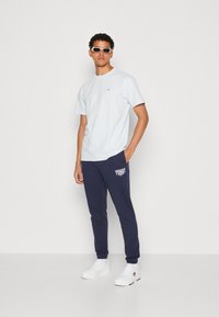Tommy Jeans SLIM ENTRY GRAPHIC SWEATPANT - Pantalones deportivos - twilight navy