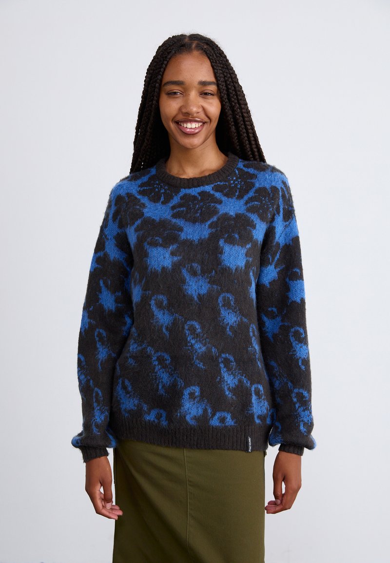 Maglione lavorato a maglia nero e blu con scollo rotondo e maniche lunghe. Presenta una consistenza morbida e polsini e orlo a coste.