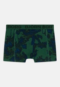 Green boxer shorts featuring a dark blue palm tree pattern, with a black waistband labeled "BORG BJÖRN BORG." Soft, stretchy fabric.
