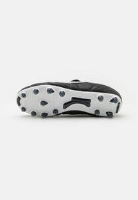 Black soccer cleat featuring a textured upper, molded plastic outsole with black studs, and a white branding accent.