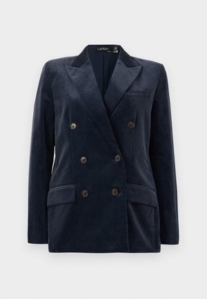 Blazer in corduroy navy con design doppiopetto, colletto a rever, due tasche frontali e bottoni marroni. In tessuto testurizzato, vestibilità su misura.