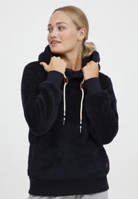 Navy blue fleece hoodie with a textured surface, adjustable drawstring, and ribbed cuffs. Features a kangaroo pocket and logo detail.