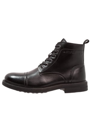 Bottine en cuir noir avec fermeture à lacets à l'avant, bout arrondi, languette au talon et semelle en caoutchouc.