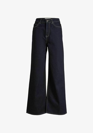 Calças de ganga escuras de perna larga com uma cintura alta, apresentando costuras amarelas em contraste e um design limpo e estruturado.