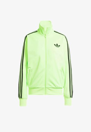 Neona zaļa zip-up veste, izgatavota no gludas auduma, ar melnām sānu svītrām, ribotām piedurknēm un Adidas logo uz kreisā krūts.