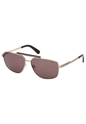 Occhiali da sole in metallo dorato con lenti scure, design angolare e terminali in acetato nero. Presenta un doppio ponte per uno stile aggiuntivo.