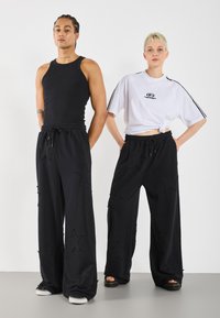 YOURTURN UNISEX - Teplákové kalhoty - black