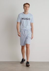 BOSS HEADLO - Spodnji deli trenirk - light blue