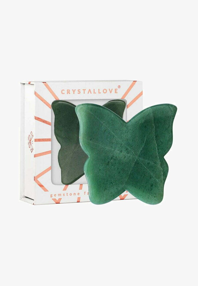 Groene edelstenen gezichtsapparaat in de vorm van een vlinder, met een gladde textuur en subtiele adering, verpakt in een witte doos met rode accenten.