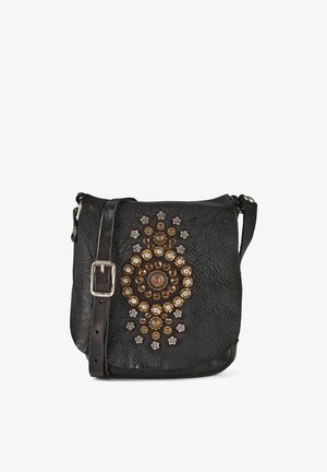 Black leather crossbody bag with adjustable strap and decorative circular metal and jeweled studs on front flap.