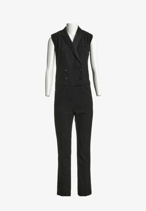 Combinaison blazer noire sans manches à double boutonnage avec col à revers et pantalon droit, présentée sur un mannequin blanc.