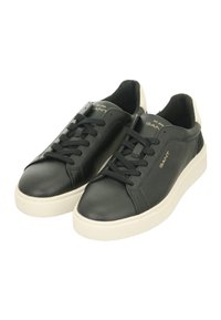 Black leather sneakers with a smooth finish, round toe, flat white rubber sole, black laces, and a beige heel accent. Brand logo on tongue.
