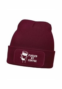 Burgundy knit beanie featuring a cuff with a rectangular patch displaying white text "FUELED BY COFFEE" and a graphic of a coffee cup.