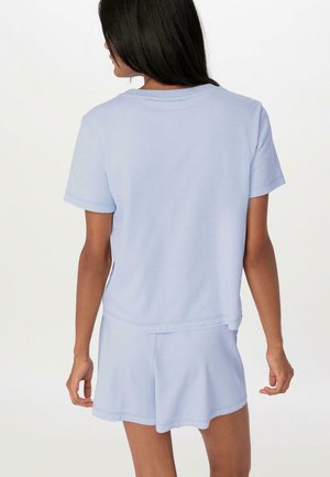 Light blue short-sleeve t-shirt with a relaxed fit, paired with matching shorts. Soft fabric and simple design, featuring a rounded hem.