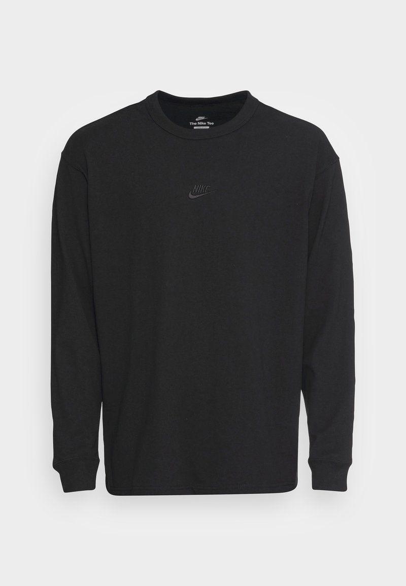 Schwarzes Langarmshirt aus Baumwolle mit geripptem Rundhalsausschnitt, lässiger Passform und kleinem schwarzen Nike-Logo auf der Brust.