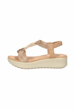 Sandalo beige con zeppa, cinturini intrecciati, fascia elastica alla caviglia e suola imbottita, progettato per un uso casual.