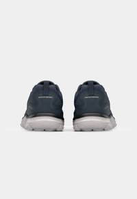 Navy athletic shoes with a breathable mesh upper, cushioned sole, and a grey outsole. Features logo on the heel and pull tab.