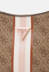 Brown textured handbag featuring a triangular gold logo plaque, accented with pink and white vertical stripes. Smooth and patterned surface details.