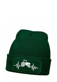 Dark green beanie hat made of ribbed fabric, featuring a white tractor illustration and heartbeat line on a rectangular patch.