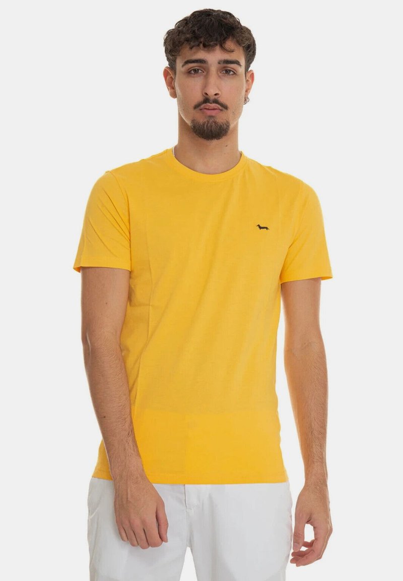 T-shirt di cotone gialla con collo rotondo, maniche corte e un piccolo logo nero sul petto. La vestibilità è casual, con una consistenza morbida.