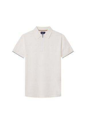 Pikee lyhythihainen off-white-värissä, jossa on vetoketjukaulus. Materiaali on teksturoidu ja hihoissa on kontrastiväriset tummansiniset yksityiskohdat.