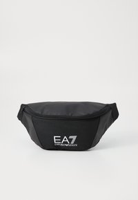 Sacoche noire avec fermeture éclair, arborant le logo EA7 Emporio Armani en blanc. L'arrière-plan est entièrement blanc.