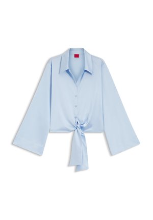 Light blue long-sleeve blouse with wide sleeves, button front, large collar, and a tied knot at the waist.