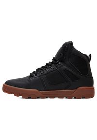 Black high-top boots featuring a mix of smooth leather and textured synthetic panels. Rubber outsole with a contrasting brown color, and eyelet detail.