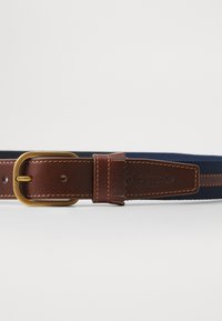 Brown leather belt with a gold buckle, featuring navy fabric and brown leather accents. Includes stitched detailing and logo.