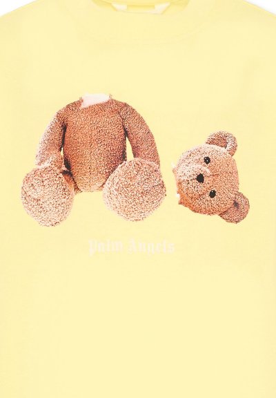 Vêtement jaune avec un motif d'ours en peluche à la tête détachée et le texte "Palm Angels" en dessous du design.