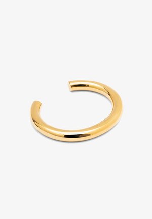 Pulsera de brazo de metal en tono dorado con una superficie lisa y brillante y un diseño abierto y redondeado. No presenta adornos ni patrones visibles.