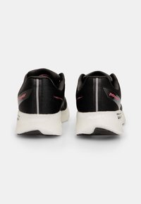 Black athletic shoes with a lightweight mesh upper, contrasting red accents, and a white cushioned sole. Features a textured rear for stability.