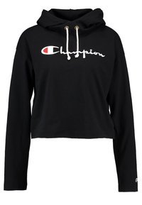 Zwarte cropped hoodie van katoen, met een wit "Champion" logo en trekkoorden met gouden metalen accenten. Lange mouwen en een losse pasvorm.