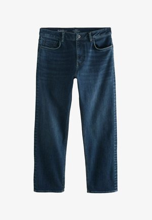 Tmavomodré džíny z denimu so strihom rovného nohavicu, piatimi vreckami a zipsom. Majú jemné vyblednutie na stehnách a klasický prešitý pás.