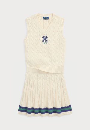 Sleeveless cream knitted dress with cable pattern, featuring a blue embroidered logo and green accents on the skirt's hem.
