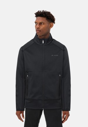 Giacca nera con zip realizzata in un morbido tessuto testurizzato, dotata di un colletto alto, tasche laterali con zip e dettagli di cucitura a contrasto.