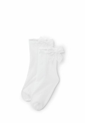 Chaussettes blanches aux chevilles avec bordure en dentelle et nœuds décoratifs près du haut, présentées côte à côte sur un fond blanc.