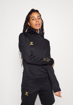 Black athletic pullover with high collar, gold logo and accents. Features long sleeves and a relaxed fit, made from a smooth, breathable fabric.