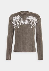 Ribbed, long-sleeve sweater in dark olive green with a white floral design across the chest. Round neckline, fitted silhouette, soft texture.