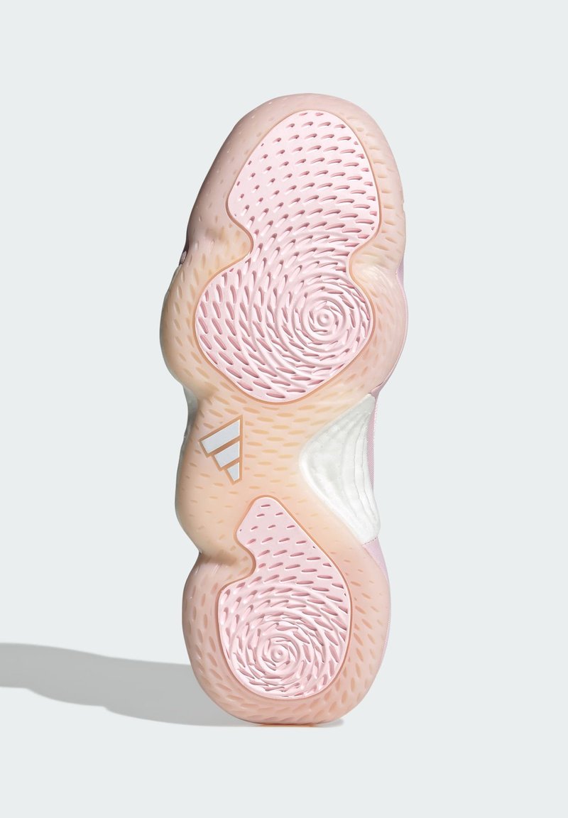Suela de zapato en rosa y crema con patrones texturizados. Presenta diseños en espiral y circ un lares, e incluye un logo de tres rayas en blanco.