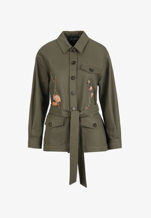 Olive green belted jacket with button closure, flap pockets, and floral embroidery on the front sides.
