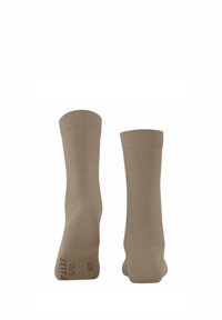 Chaussettes beiges jusqu'aux chevilles en matériau doux. Bords côtelés pour une meilleure tenue. Marquage notoire sur la semelle avec les détails de taille.