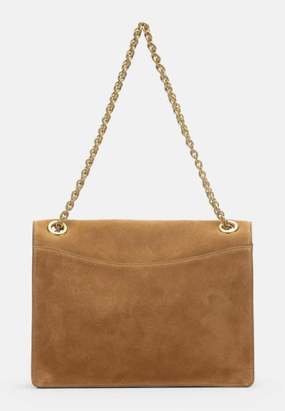 Tan suede shoulder bag with a gold chain strap and a curved seam detail on the front against a plain background.