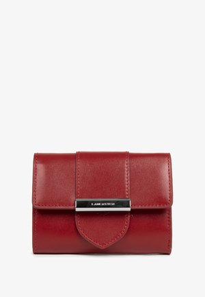 Red leather wallet with flap closure and silver metal bar engraved with "LANCASTER" logo on front center.