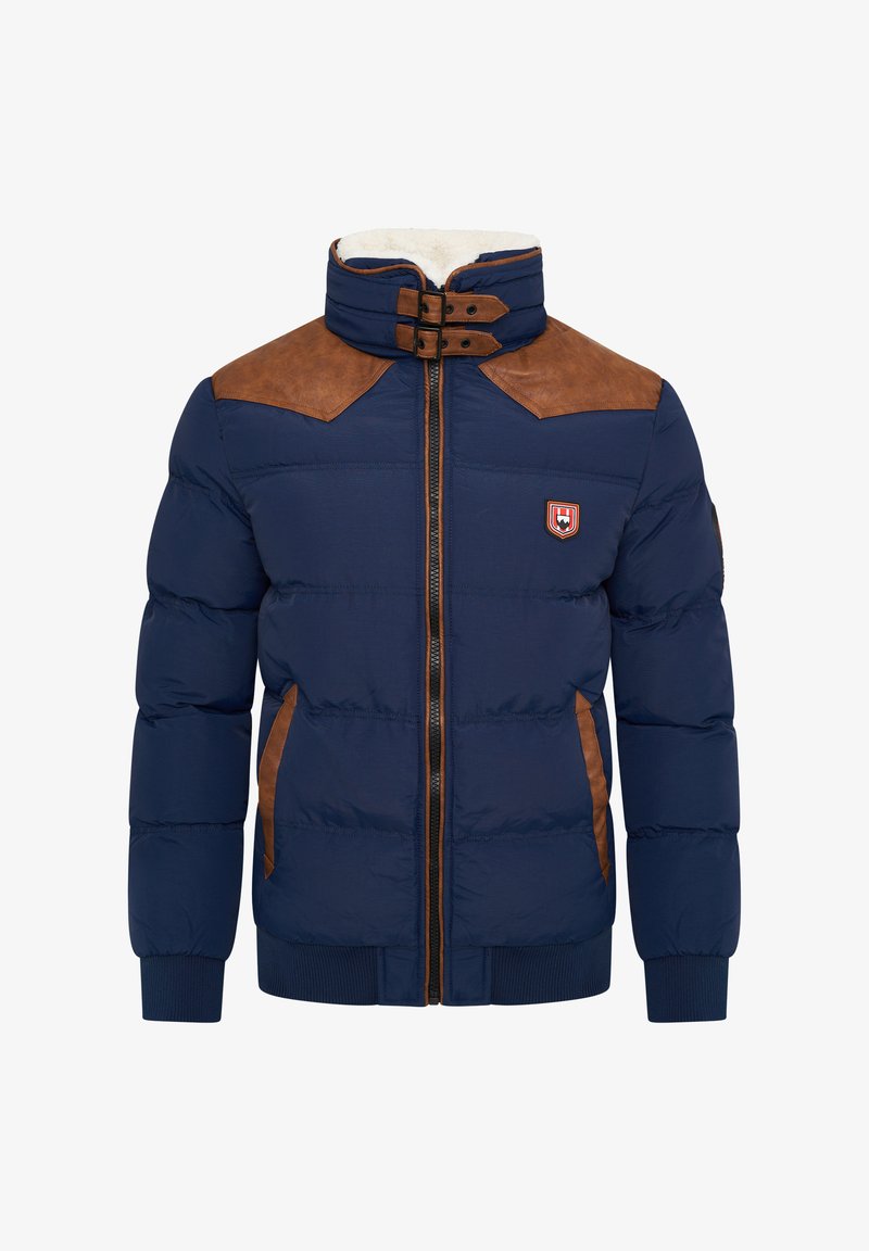 Marineblaue Pufferjacke mit braunen Leder-Schulterpatches, Reißverschluss, hohem Kragen, gerippten Manschetten und Seitentaschen. Mit einem Abzeichen auf der Brust.