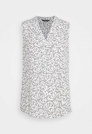Mouwloze witte blouse met zwart delicaat takken- en bladerenpatroon, V-halskraag en losse pasvorm.